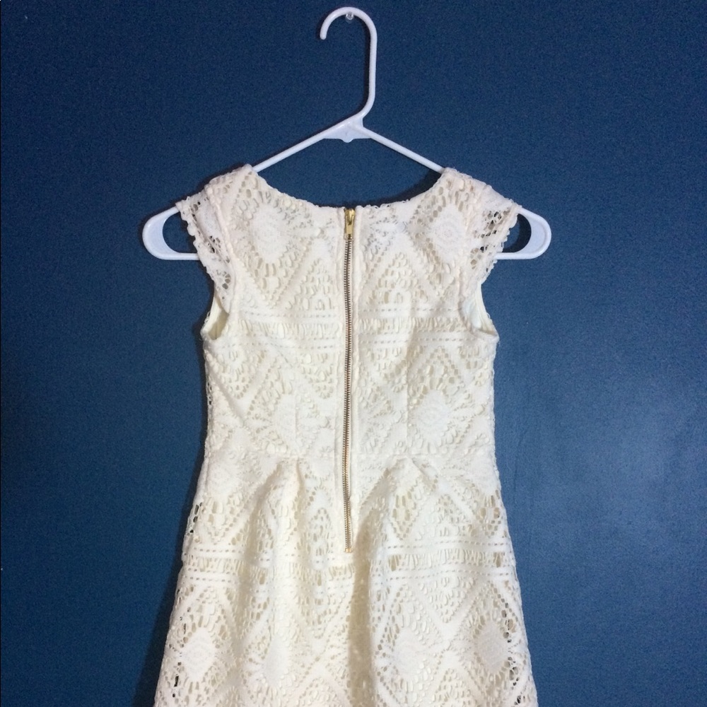 Creame-colored girl’s lace dress